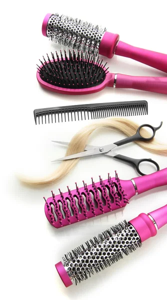 Comb brushes, hair and cutting shears, isolated on white — Stock Photo, Image