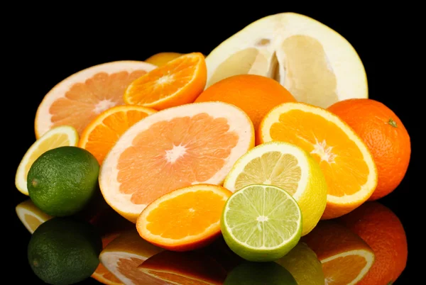 Lots ripe citrus isolated on black — Stock Photo, Image