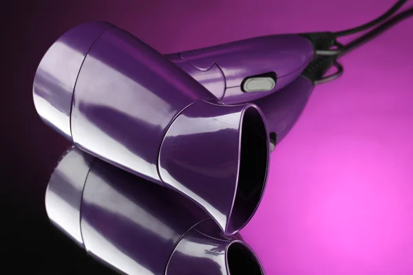 Hair dryer on purple background — Stock Photo, Image