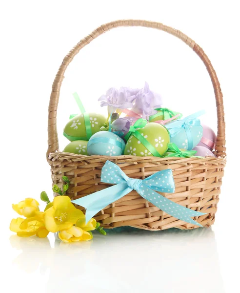 Bright easter eggs with bows in basket, isolated on white — Stock Photo, Image