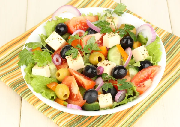 Insalata fresca in piatto su tavolo di legno — Foto Stock