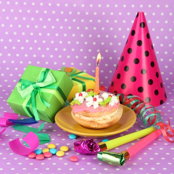 Colorful birthday cake with candle and gifts on pink background — Stock Photo, Image