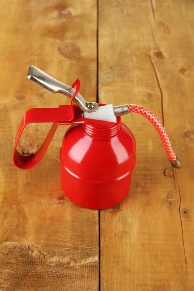 Red oil can, on wooden background — Stock Photo, Image