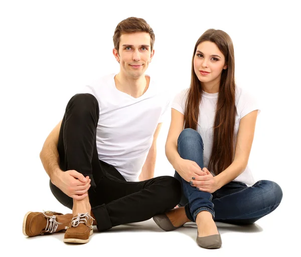 Loving couple sitting with back to each other on floor isolated on white — Stock Photo, Image