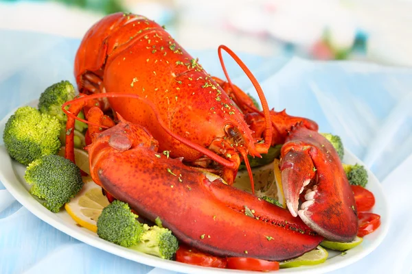 Red lobster on platter with vegetables on table close-up — Stock Photo, Image