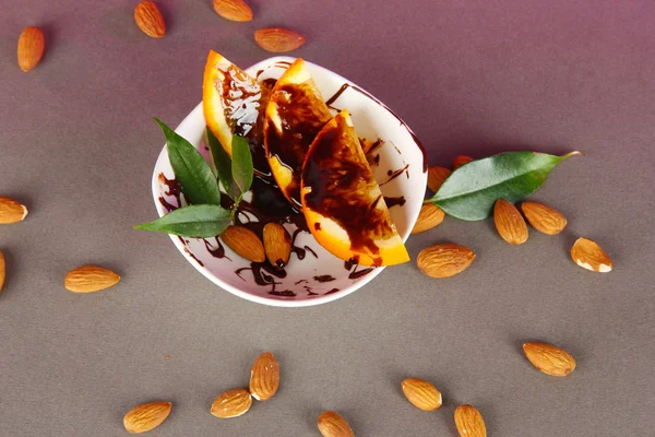 Fruit in chocolate against a gray background — Stock Photo, Image