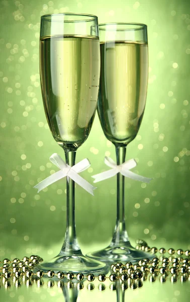 Two glasses of champagne on bright background with lights — Stock Photo, Image