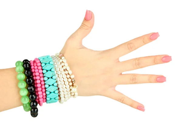 Female hand with pink manicure and bright bracelets, isolated on white — Stock Photo, Image