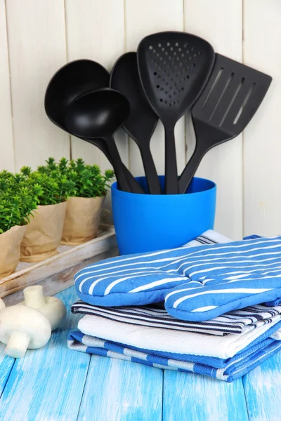 Nastavení kuchyně: nádobí, chňapky, ručníky a jinde na dřevěný stůl — Stock fotografie