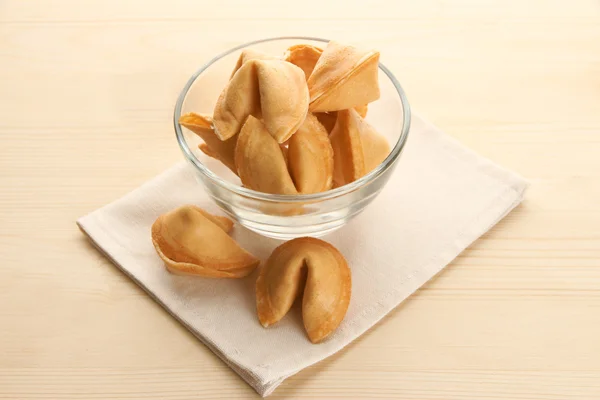 Fortune cookies in bowl, on wooden table — Stock Photo, Image