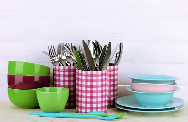 Cups, bowls nd other utensils in metal containers isolated on light background — Stok fotoğraf