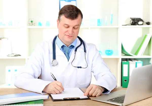 Medical doctor working at desk — Stock Photo, Image