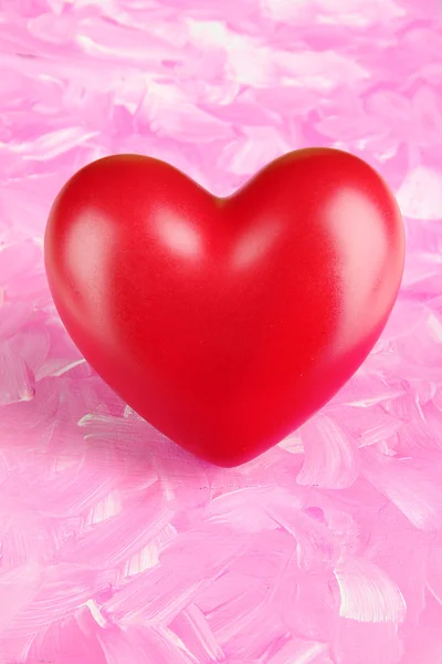Декоративное красное сердце на цветном фоне — стоковое фото