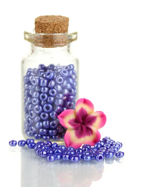 Little bottle full with colorful beads isolated on white — Stock Photo, Image