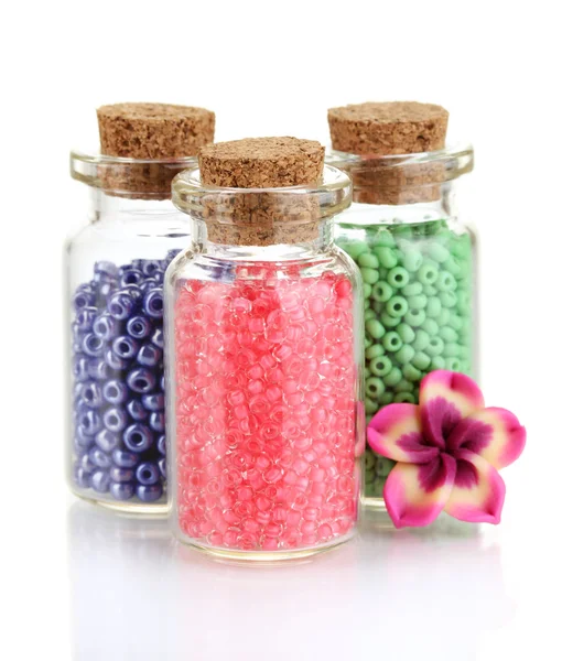 Little bottles full with colorful beads isolated on white — Stock Photo, Image