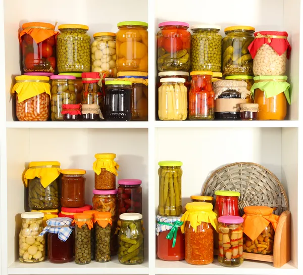 Different conservations on white shelves — Stock Image Different conservations on white shelves Stock Picture