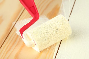 rulo fırça ahşap zemin üzerinde beyaz boya ile boyayın.