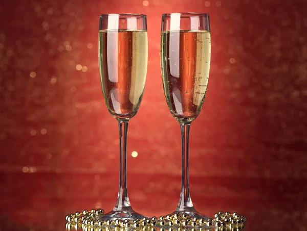 Two glasses of champagne on bright background with lights — Stock Photo, Image