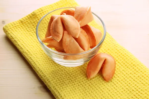 Fortune cookies in bowl, on wooden table — Stock Photo, Image