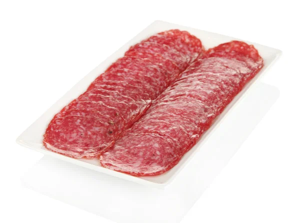 Smakelijke salami op plaat geïsoleerd op wit — Stockfoto