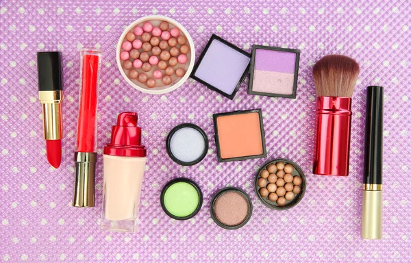 Decorative cosmetics on purple background — Stock Photo, Image