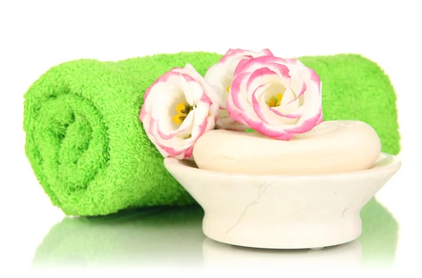 Rolled green towel, soap bar and beautiful flower isolated on white — Stock Photo, Image