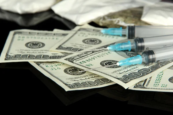 Drugs, money and syringes, isolated on black — Stock Photo, Image