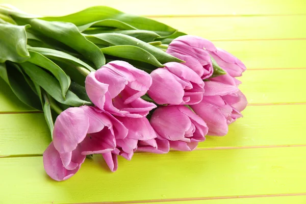 Hermoso ramo de tulipanes morados sobre fondo de madera verde — Foto de Stock