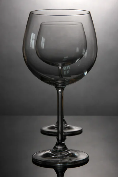 Empty wine glasses arranged on grey background — Stock Photo, Image