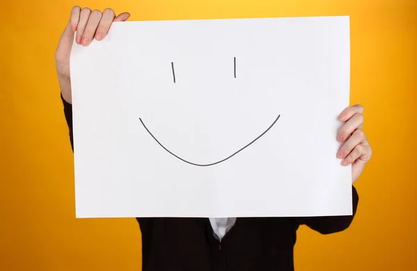 Woman holding paper with smile, on color background — Stock Photo, Image