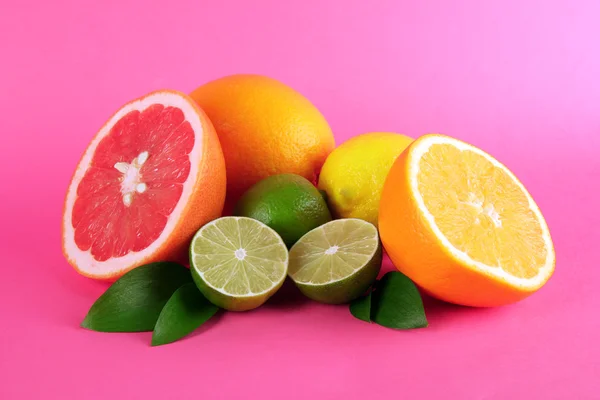 Fruits with leafs on pink background — Stock Photo, Image