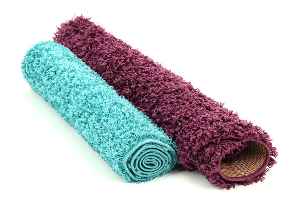 Two rolled carpets isolated on white