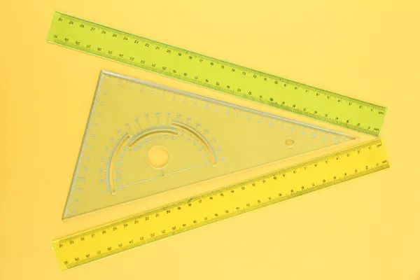 Rulers on yellow background — Stock Photo, Image