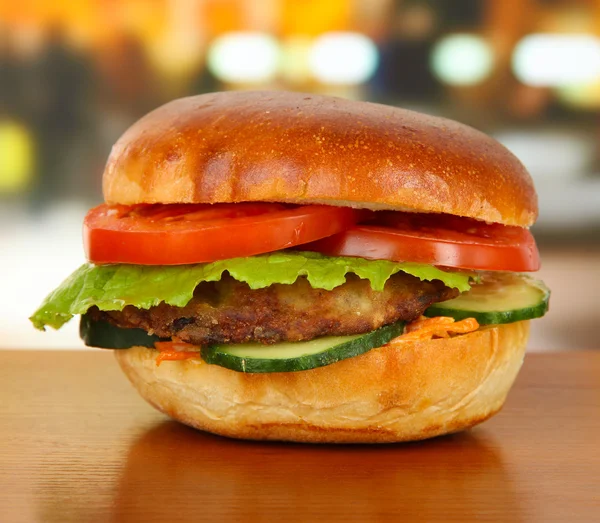 Big and tasty hamburger on table in cafe — Stock Photo, Image