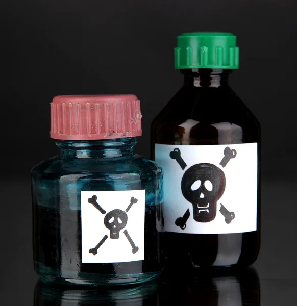 Deadly poison in bottles on black background — Stock Photo, Image