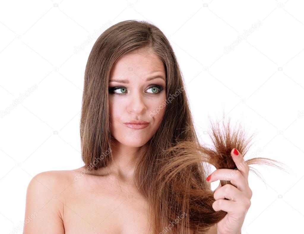 Beautiful woman holding split ends of her long hair, isolated on white