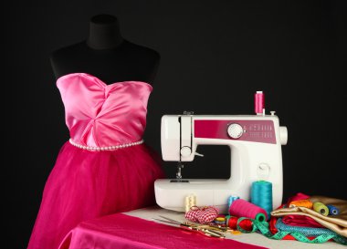 Sewing machine, dummy and other sewing equipment isolated on black clipart