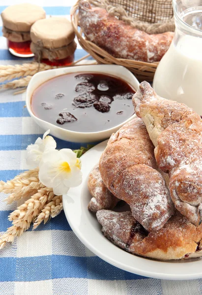 Taste croissants, milk and jam, on tableclot — Stock Photo, Image