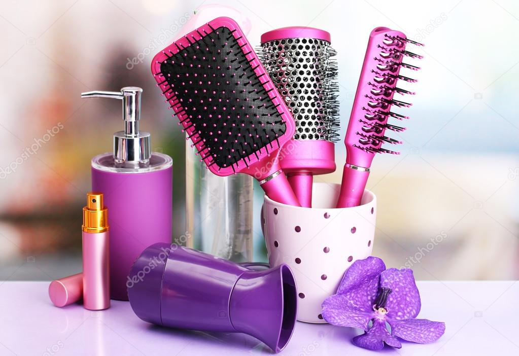 Hair brushes, hairdryer and cosmetic bottles in beauty salo