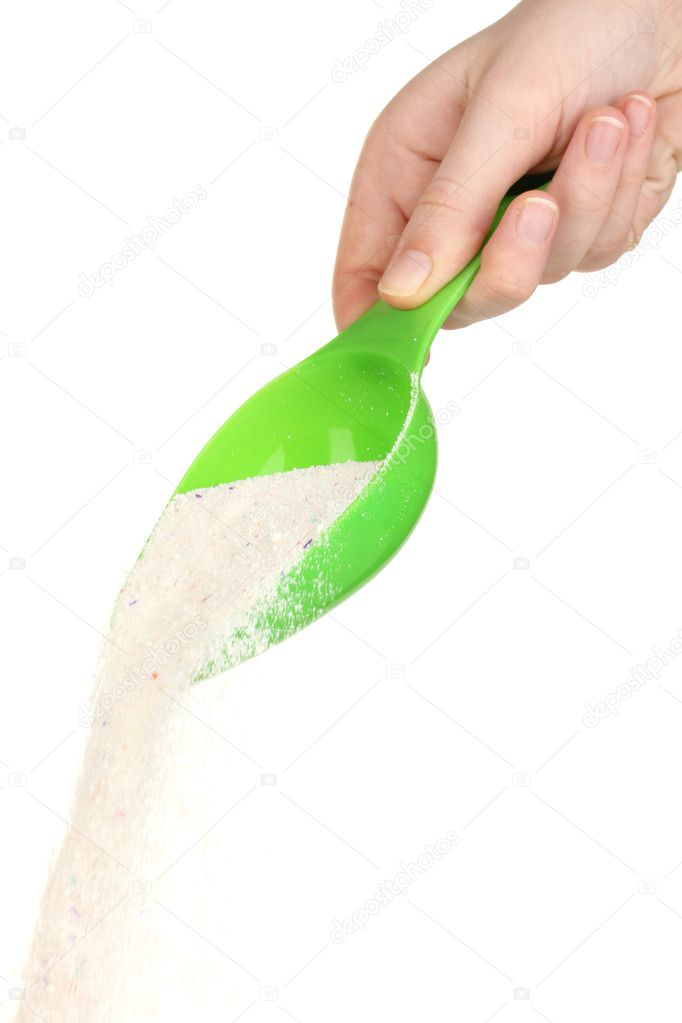 Measuring cup with washing powder in hand isolated on white