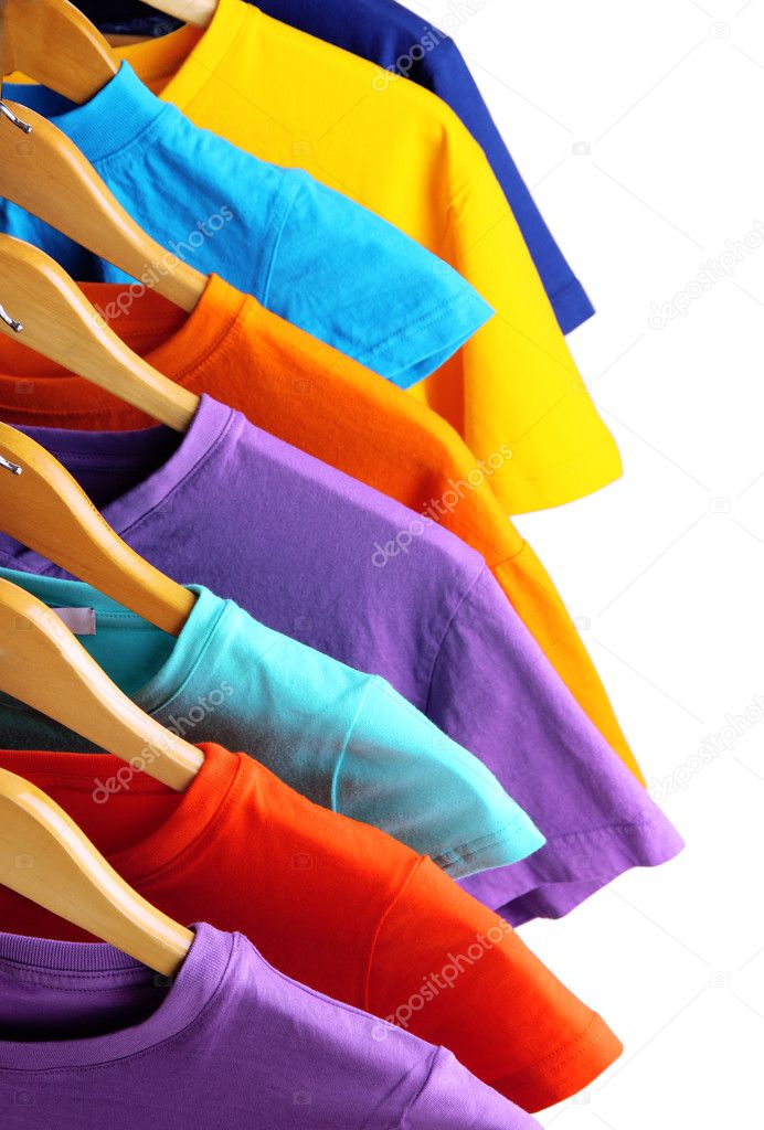 Lots of T-shirts on hangers isolated on white