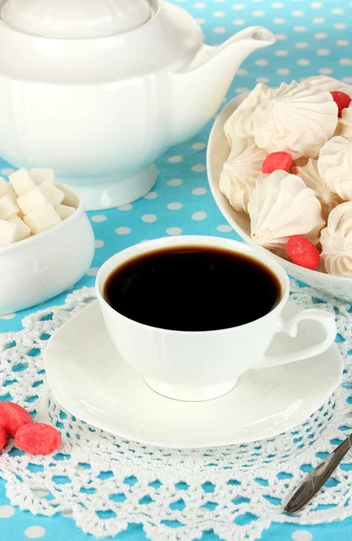 Beautiful white dinner service with an air meringues on blue tablecloth close-up — Stock Photo, Image