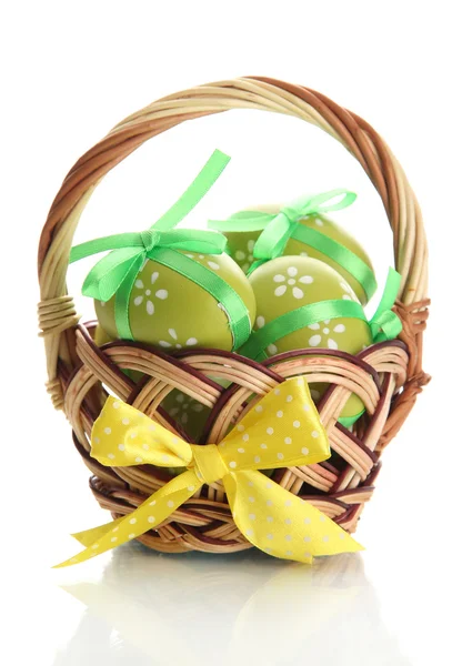 Bright easter eggs with bows in basket, isolated on white — Stock Photo, Image