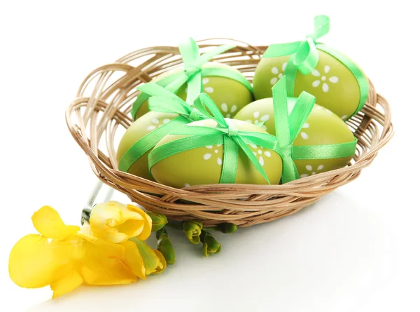 Bright easter eggs with bows in basket, isolated on white — Stock Photo, Image