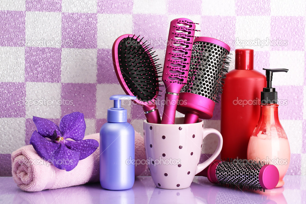 Hair brushes and cosmetic bottles in bathroo