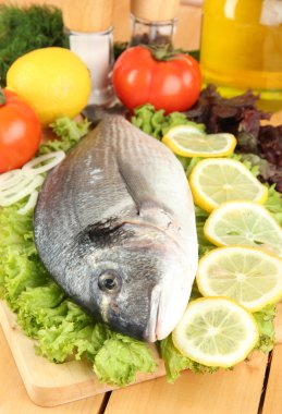 doğrama kurulu limon ve sebzeler üzerinde ahşap masa üzerinde taze dorado