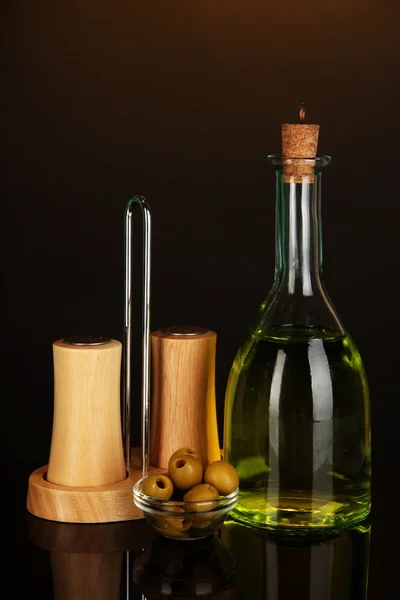 Original glass bottle with oil on dark color background — Stock Photo, Image