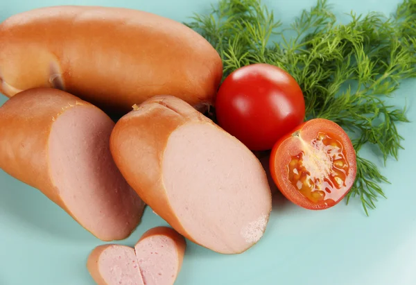 Sausage, greens, tomato on plate — Stock Photo, Image