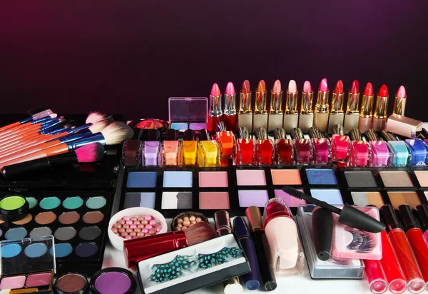 Lot of different cosmetics on purple background — Stock Photo, Image