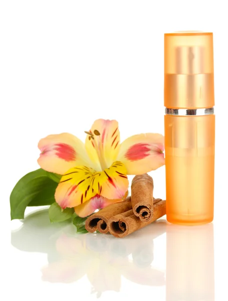 Women's perfume in beautiful bottle with flower and cinnamon isolated on white — Stock Photo, Image